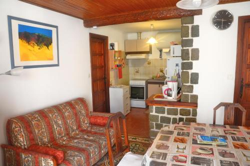 a living room with a couch and a kitchen at Location Pierre in Tende
