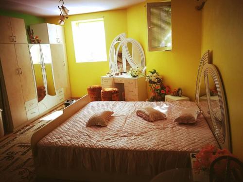a bedroom with a bed with two pillows on it at Two Bedroom Townhouse Mika in Ruse
