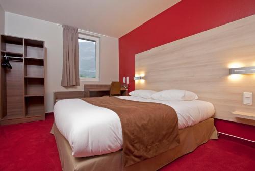a hotel room with a large bed and a window at Ekho Hotel Grenoble Nord Saint Egrève in Saint-Égrève