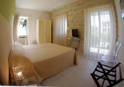 a bedroom with a bed and a television in it at La Piccola Locanda in Modica