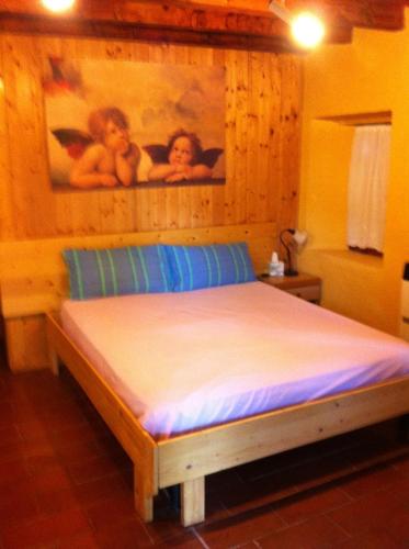a bedroom with a bed with a wooden wall at Prà de Mandè in Viano