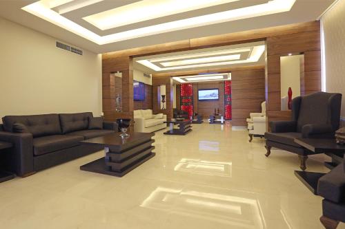 a living room with couches and tables in a room at Ibiza Hotel in Jounieh