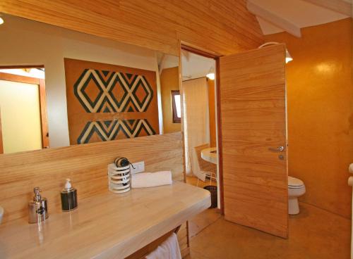 a bathroom with a sink and a toilet in it at Altiplanico Rapa Nui in Hanga Roa