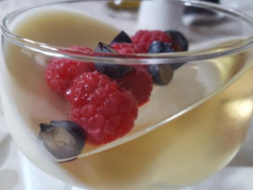 a glass dish with raspberries and blueberries at Top Penzión Marína in Dolný Kubín