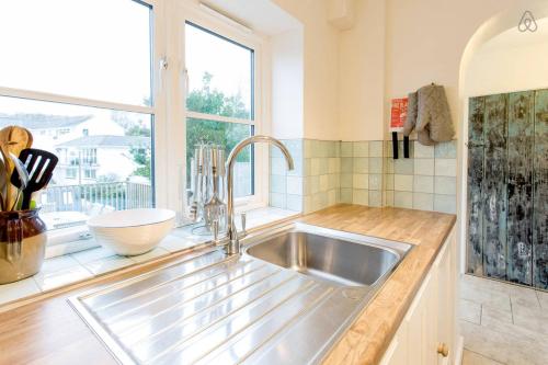 a kitchen with a sink and a window at Fisherman's Cottage in Saint Mawes