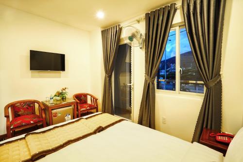 een slaapkamer met een bed en een raam bij Thanh Thanh Hotel in Quy Nhon