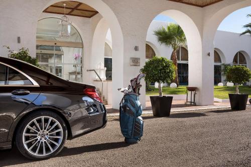 a car parked in front of a building with a statue at Melia Marbella Banús in Marbella