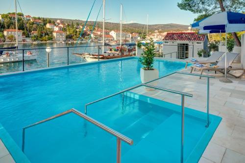 a swimming pool with a view of the water at Hotel Milna Osam - Adults Only in Milna