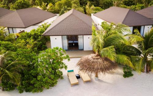 an aerial view of a house with two chairs and trees at ROBINSON NOONU - All Inclusive in Manadhoo