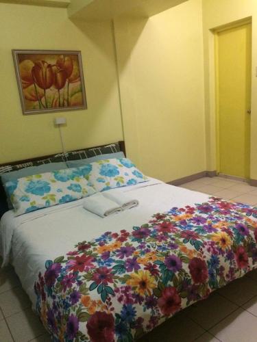 a bedroom with a bed with flowers on it at Leons Den is a long term accomodation of atleast 1 month stay in Manila
