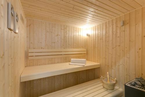 a wooden sauna with a towel on a shelf at Superior Villa Marina Mare with Sauna Hammam & Parking in Nea Kydonia