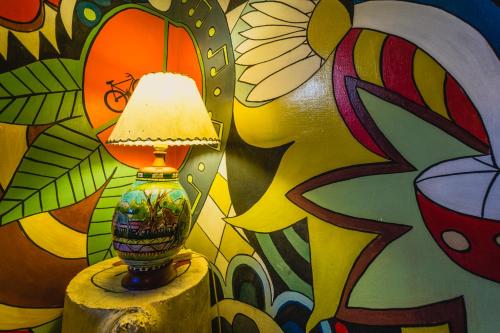 a lamp sitting on a table in front of a wall at The Trip Hostel in Punta del Este