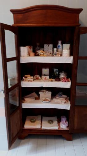 a book shelf filled with dishes and food at B&B Villa Ada in Formia