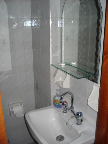 a white sink in a bathroom with a mirror at Stella Rooms in Kardamili