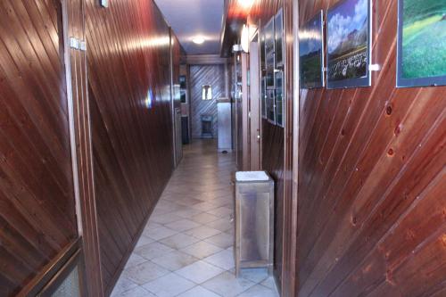 a hallway in a train with wooden walls and a tile floor at Locanda San Giorgio in Sestola