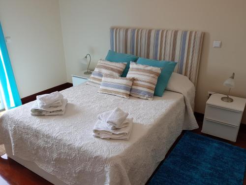 a bedroom with a bed with towels on it at Vila Régia in Funchal