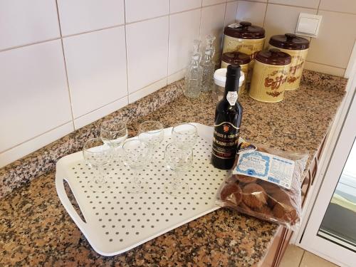 a bottle of wine and glasses on a counter at Vila Régia in Funchal