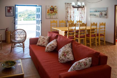 a living room with a red couch and a table at Quinta Montebelo in Vila Franca de Xira