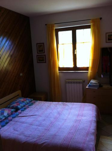 a bedroom with a bed and a window at Locanda San Giorgio in Sestola