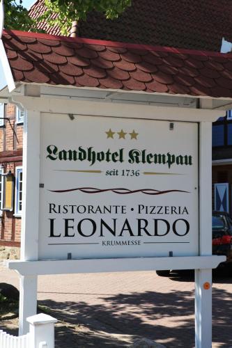 a sign that reads antiquated elginitution in a street at Landhotel Klempau in Lübeck