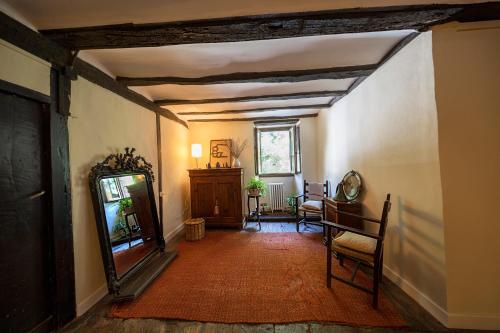 a hallway with a mirror and a table and chairs at Goiko-Benta Ostatua in Oñate