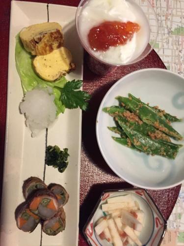 a plate of food with vegetables and other foods at Gallery Nozawa Inn in Kyoto