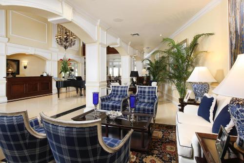 a living room with a couch and chairs and a table at Inn at Pelican Bay in Naples