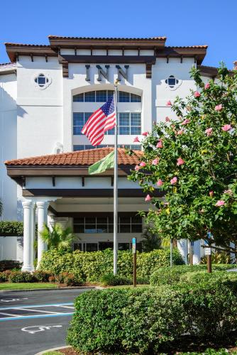 an american flag flying in front of a building at Inn at Pelican Bay in Naples
