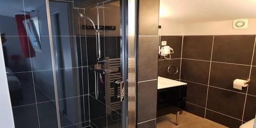 a bathroom with a shower with a glass door at Le Domaine d'Alèzen in Grans