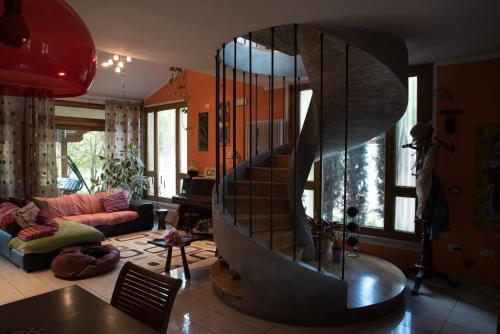 a living room with a spiral staircase in the middle at La Luce della Luna in Castelnovo Bariano