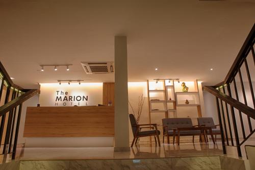 a room with a table and chairs and a sign at The Marion Hotel in Johor Bahru