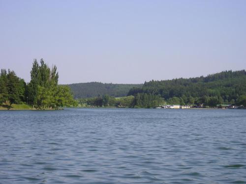 a large body of water with trees in the background at Apartmány Jedovnice in Jedovnice