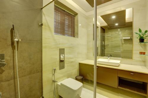 a bathroom with a toilet and a sink and a shower at Nadhiyoram River Retreat in Cochin