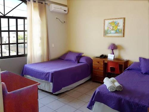 Una cama o camas en una habitación de Mirador Hotel