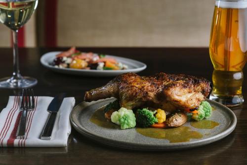 a plate of food with a chicken and broccoli on a table at Fairmont Copley Plaza in Boston