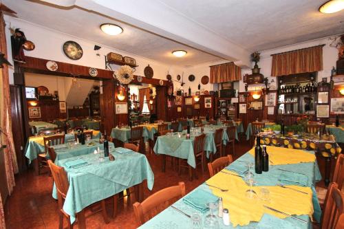 a restaurant with tables and chairs with blue table cloth at Albergo Santo Spirito in Molini di Triora