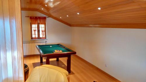 a room with a pool table in a house at Casa da Quinta in Oliveira do Hospital