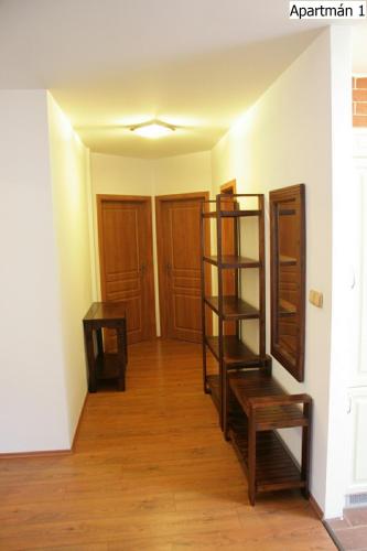 an empty room with a book shelf and a table at Apartmány Horní Planá in Horní Planá