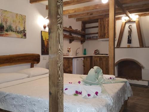 a room with two beds and a kitchen at Karya Apartments in Koycegiz