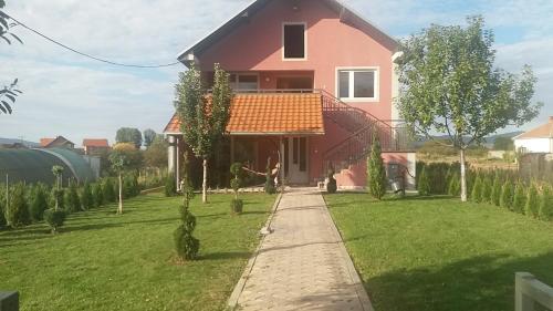 a house with a pathway in front of it at Apartments "Predah kod Baraća" in Niš