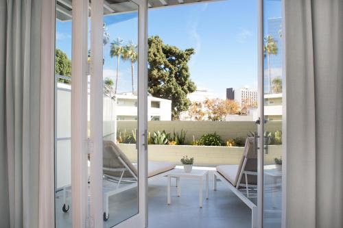 a balcony with a table and chairs on a building at Avalon Hotel Beverly Hills, a Member of Design Hotels in Los Angeles