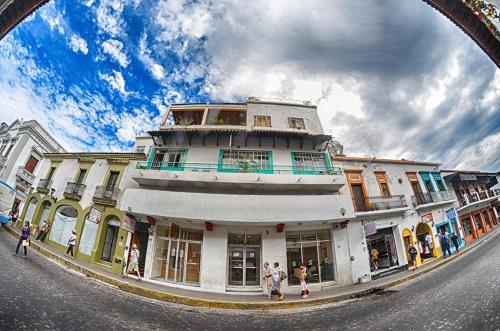 a group of people walking in front of a building at Casa Kraken Hostel in Puerto Vallarta