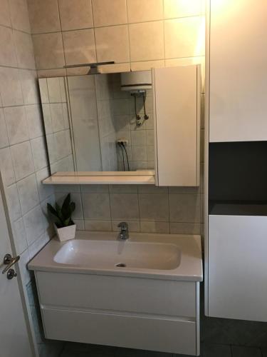 a bathroom with a sink and a mirror at Apartment Abba in Kali