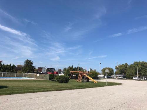 a playground with a slide in a park at The Gables Inn in Sarnia