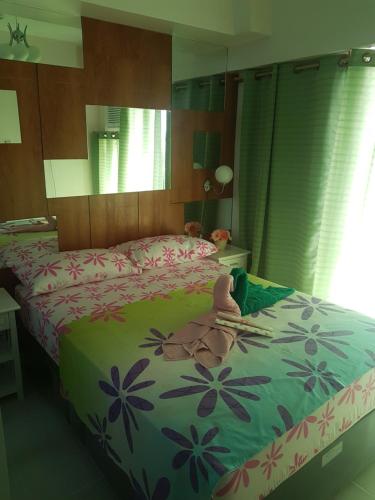 a bedroom with two beds with towels on it at EAM LAKE VIEW @ TAGAYTAY PRIME RESIDENCES in Tagaytay