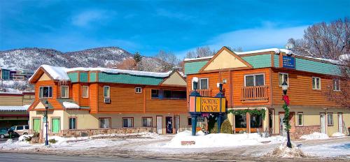 a large wooden building on the side of a street at Nordic Lodge in Steamboat Springs