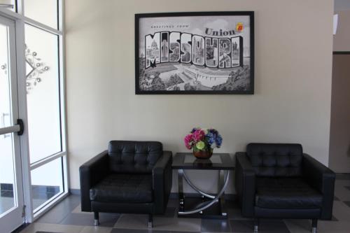 a waiting room with two chairs and a table at Super 8 by Wyndham Union in Union