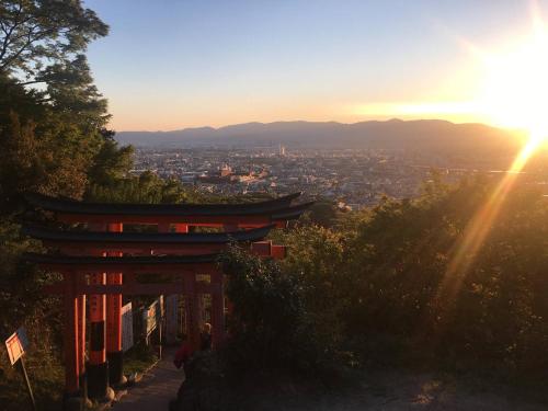 a sunset over a city with a pagoda at Calligraphy House in Kyoto