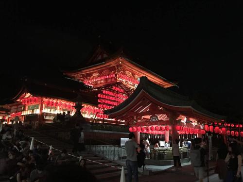 a building with red lights on it at night at Calligraphy House in Kyoto
