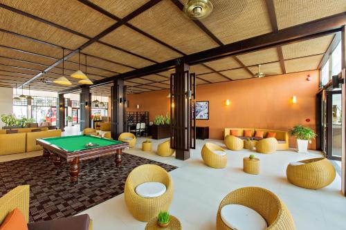 a room with a pool table and some chairs at Hoi An Beach Resort in Hoi An